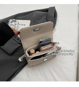 Interior view showing the spacious main compartment and zipper pocket of the cream flap bag