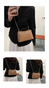 Detail of a brown lychee pattern leather vanity bag with silver metal chain strap