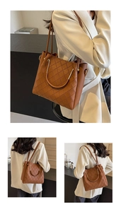 Close-up of brown quilted tote bag featuring golden metal handles and leather texture
