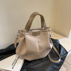 Large beige canvas tote bag with pleated design and detachable strap for daily commuting