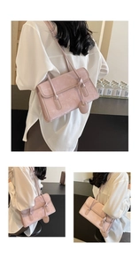 Detail view of pink suede shoulder bag showing rectangle flap and slim leather strap
