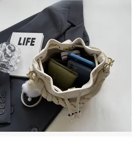 Interior view of beige bucket bag showing spacious capacity for wallet and phone