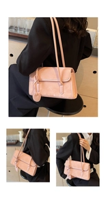 Detail view of pink suede shoulder bag featuring a sleek rectangular design and heart charm