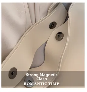 Detail of strong magnetic closure on beige pebbled leather tote bag with ROMANTIC TIME logo