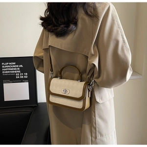 Detail of rhombic embossed crossbody bag with silver twist lock and retro top handle