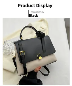 Detail view of contrast color handbag with black flap and metal circular lock closure