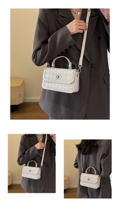 Detail view of cream quilted crossbody bag featuring elegant silver twist lock and stitching