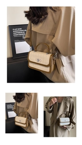 Detail of color-block rhombus crossbody bag with silver rotating clasp and brown trim