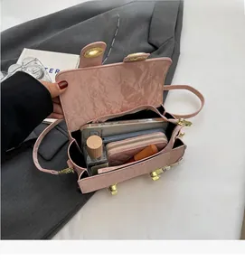 Internal view of pink pleated leather handbag showing capacity for phone and cosmetics