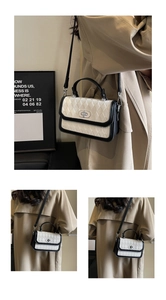 Detail of contrast rhombus quilted handbag with silver oval twist lock and top handle