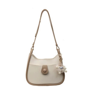 Chic beige and brown PU leather bucket bag with plush charm on a clean white background