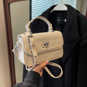 Quilted off-white crossbody bag with silver buckle and contrasting stitch detailing