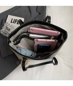 Internal view of large beige tote bag with multi-layer pockets for laptop and books