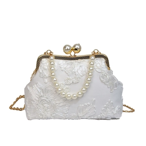 Elegant white lace evening handbag with large pearl kiss lock and golden chain strap
