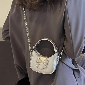 Silver mini bow crossbody bag with metallic chain strap and stylish top handle