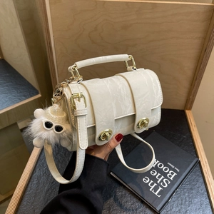 Elegant white marble pattern handbag with dual gold twist locks and plush charm