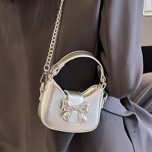 Silver metallic bow handbag with chain strap, minimalist leather crossbody crescent bag