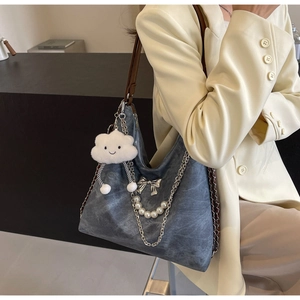 Chic grey washed tote bag featuring pearl chain, bow detail, and plush cloud charm accessory