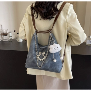 Blue denim half-moon backpack with pearl chain detail and cloud plush charm