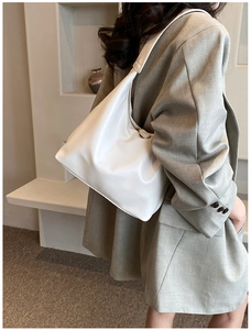Minimalist white PU leather shoulder bag styled with a grey blazer for office commuting