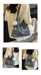 Detail view of dark grey washed tote bag with chain strap and pearl charm accessories