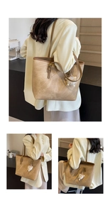 Detail view of khaki vintage tote bag with sheep charm and brown shoulder straps