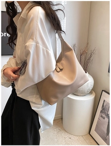 Detailed view of apricot hobo bag with soft PU leather texture and dual zipper design