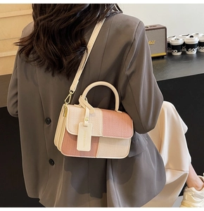 Detail of pink and white checkered crossbody bag with top handle and fashion hangtag