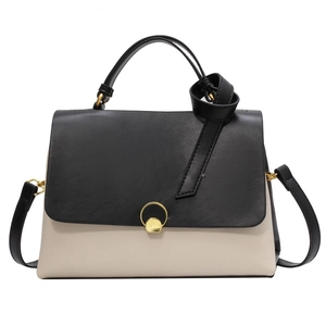 Minimalist beige and black color-block handbag with gold clasp and leather knotted handle
