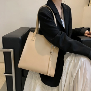 Minimalist beige soft leather tote bag with silver hardware for office and daily wear