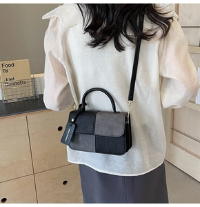 Lifestyle shot showing the two-tone patchwork crossbody bag being worn over the shoulder