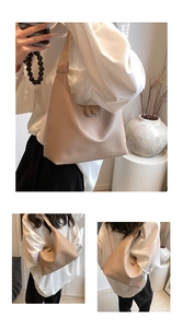Detail of minimalist beige hobo bag showing soft texture and dual zipper closure