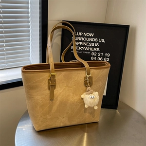 Retro large capacity tote bag in camel suede with adjustable strap and plush charm