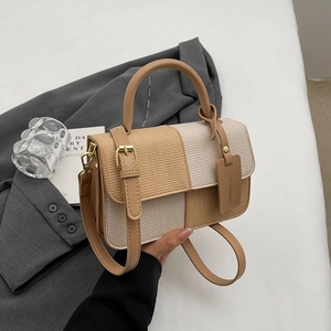 Two-tone beige woven crossbody bag with checkerboard pattern and golden metal buckles