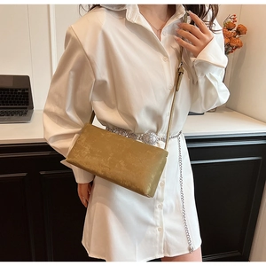 Detail of the vintage olive green leather handbag with a minimalist rectangular design