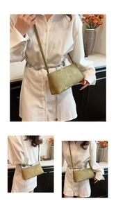 Detail of moss green matte leather shoulder bag with sleek lines and a slim strap