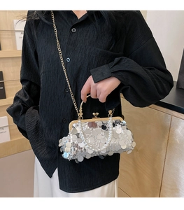 Detail der silbernen Pailletten-Abendtasche mit elegantem Perlen Griff und Goldkette