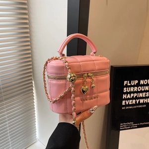Sac seau rose matelassé avec bandoulière chaîne dorée et détail de boule ajustable