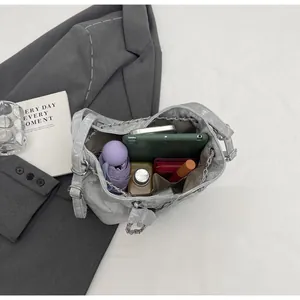 Top view of spacious silver bucket bag showing tablet, wallet and daily items inside