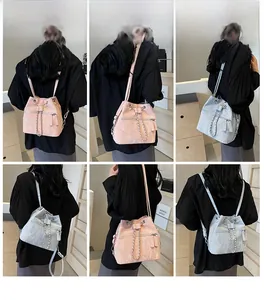 Detail of pink and blue bucket backpack with silver chain and textured leather finish