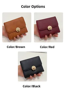 Detail of short fold wallets in brown, red and black leather with metal twist lock