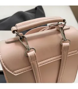 Detail of pink leather handbag top handle and high-quality silver metal buckle