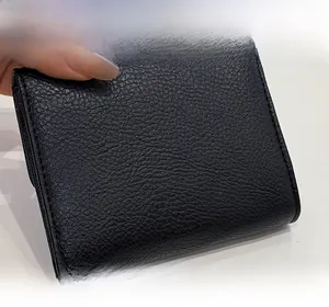 Close-up of black lychee-textured PU leather wallet showing precise stitching and soft finish