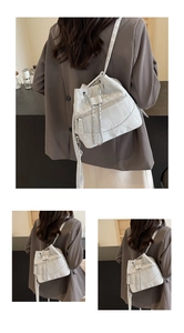 Detail of white bucket bag with pleated texture and golden chain strap for women