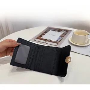 Capacity display of a black tri-fold wallet with card slots and a clear ID window