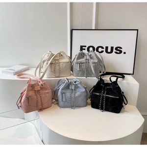 Detail showing vintage texture bucket bags in five colors with drawstring and chains