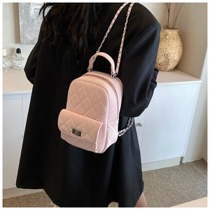 Detail of pink quilted mini backpack with chain strap and silver twist lock closure