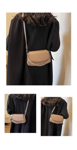 Detail view of khaki pebbled leather shoulder bag with flap design and matching strap