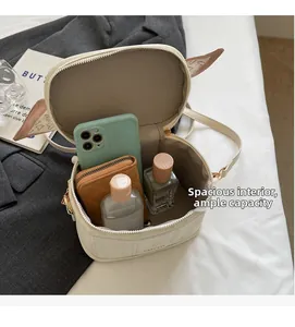 Detail of compact round crossbody bag interior with large capacity and herringbone lining
