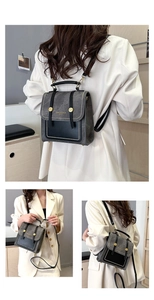 Detail of gray and black two-tone backpack with adjustable straps and gold button closure